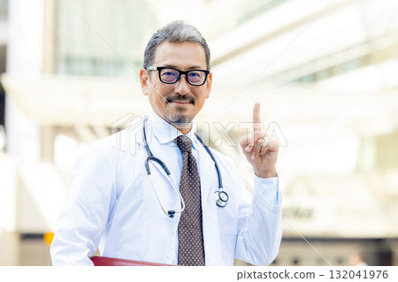 Smiling senior man wearing a white coat 132041976