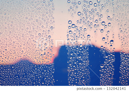 Scenery through a window with a raindrop on it, sunset, emotional, nostalgic, after the rain, humidity, background Scenery through a window with a raindrop on it, sunset, emotional, nostalgic, after the rain, humidity, background 132042141