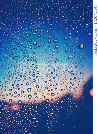 Blue landscape through a window with water droplets. Sunset. Emotional. Nostalgic. After the rain. Humidity. Background. 132042145