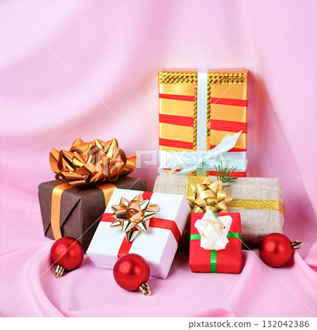 Christmas gifts in different boxes with bows on a pink background Christmas gifts in different boxes with bows on a pink background 132042386