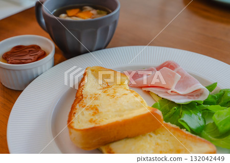 西式早餐,包括法式吐司和火腿、沙拉和湯 西式早餐,包括法式吐司和火腿、沙拉和湯 132042449