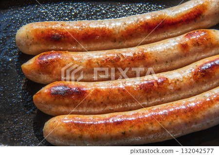 Sausages grilled on an iron plate Sausages grilled on an iron plate 132042577