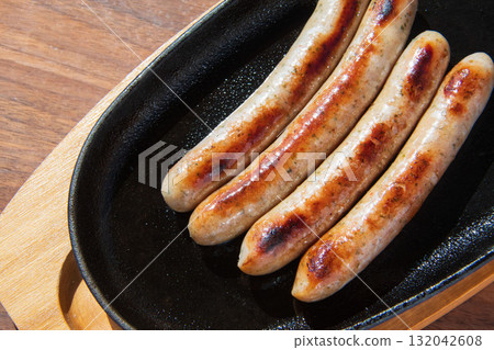 Sausages grilled on an iron plate Sausages grilled on an iron plate 132042608