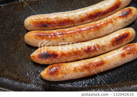 Sausages grilled on an iron plate Sausages grilled on an iron plate 132042610