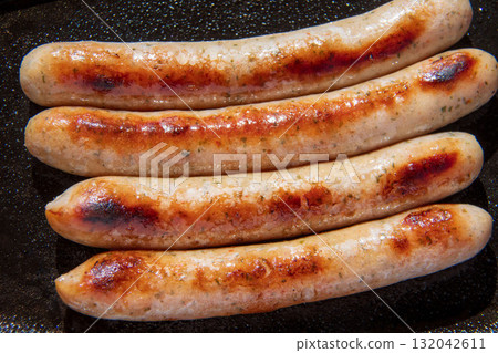 Sausages grilled on an iron plate Sausages grilled on an iron plate 132042611