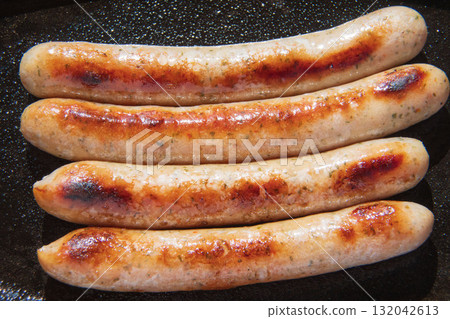 Sausages grilled on an iron plate Sausages grilled on an iron plate 132042613