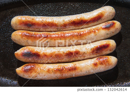 Sausages grilled on an iron plate Sausages grilled on an iron plate 132042614
