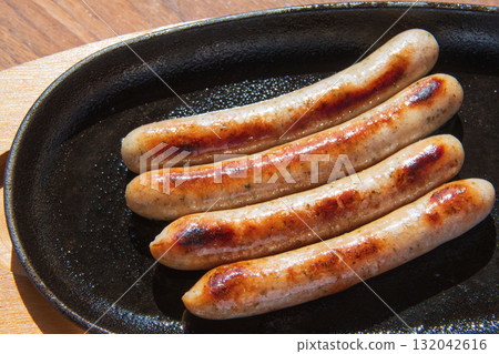 Sausages grilled on an iron plate Sausages grilled on an iron plate 132042616