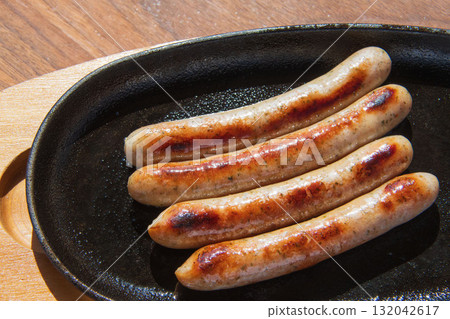 Sausages grilled on an iron plate Sausages grilled on an iron plate 132042617