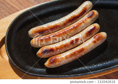 Sausages grilled on an iron plate Sausages grilled on an iron plate 132042618