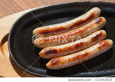 Sausages grilled on an iron plate Sausages grilled on an iron plate 132042620