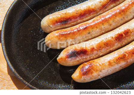 Sausages grilled on an iron plate Sausages grilled on an iron plate 132042623