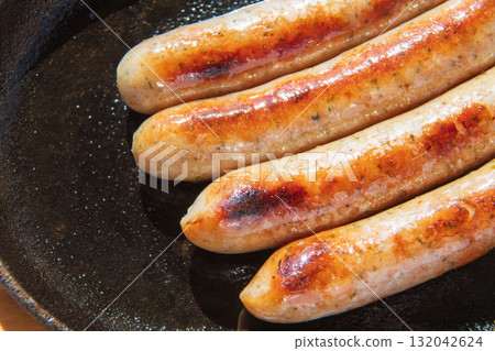 Sausages grilled on an iron plate Sausages grilled on an iron plate 132042624