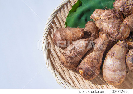 Taro leaves and taro placed on a colander 132042693