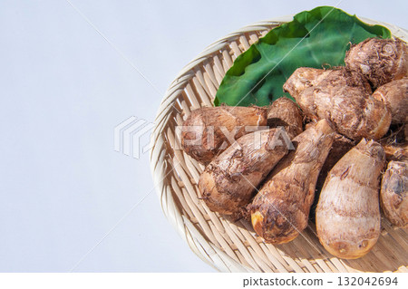 Taro leaves and taro placed on a colander Taro leaves and taro placed on a colander 132042694