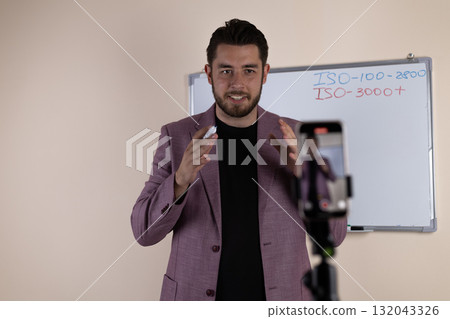 A journalist is preparing to record a video report on his smartphone A journalist is preparing to record a video report on his smartphone 132043326
