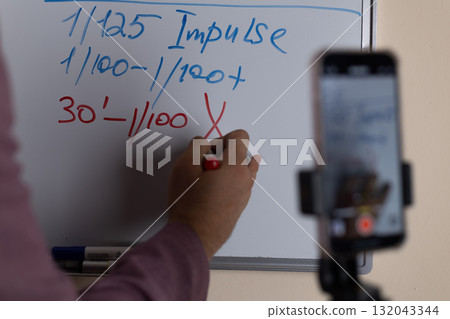 A person is recording a lesson on photography, a skill often used in photojourna 132043344
