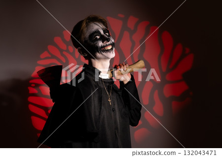 Young vampire boy holding a bat, ready for trick-or-treating on Halloween night Young vampire boy holding a bat, ready for trick-or-treating on Halloween night 132043471