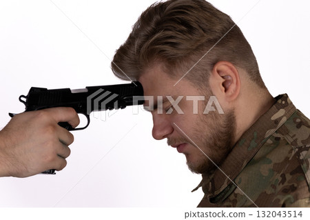 Man in camouflage clothing holding a gun, blending into forest surroundings,  132043514