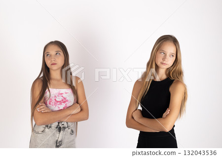 The two models are standing with their arms crossed The two models are standing with their arms crossed 132043536