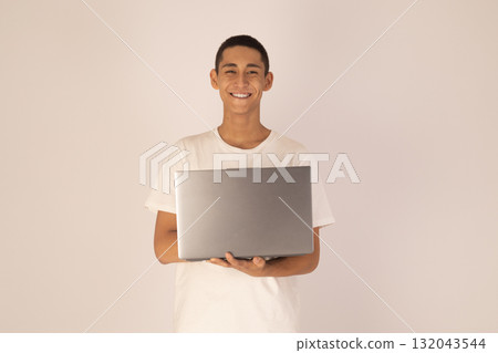 Young man holding laptop computer Young man holding laptop computer 132043544