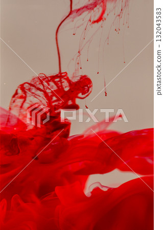 Vibrant red ink swirling in water 132043583