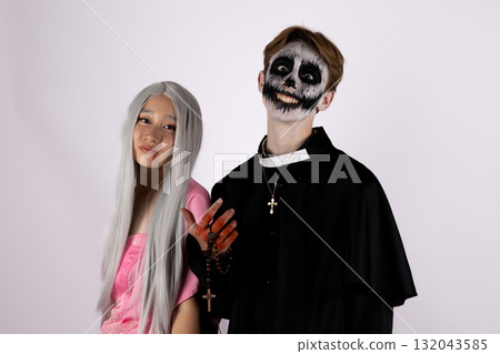 models are posing for a Halloween-themed photo, with one dressed as a skeleton models are posing for a Halloween-themed photo, with one dressed as a skeleton 132043585
