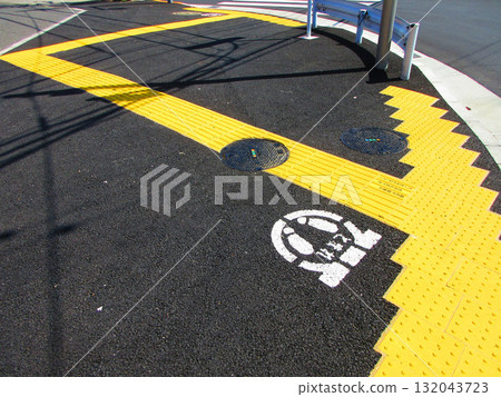 A view of tactile paving blocks (braille blocks) near a pedestrian crossing to guide the visually impaired 132043723