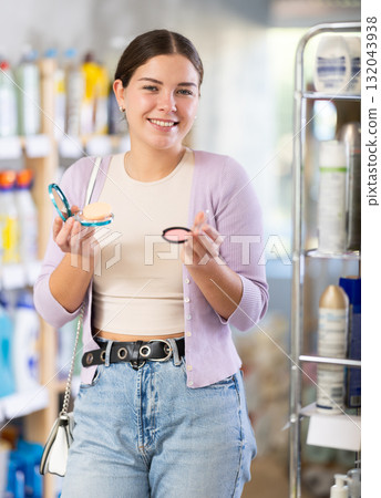 Young woman choosing cosmetics in department store Young woman choosing cosmetics in department store 132043938
