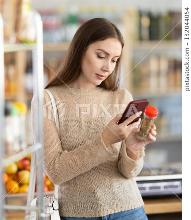 Young woman scanning qr code for seasoning herbs 132044054