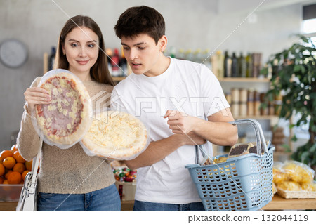 Couple young man and woman choosing pizza Couple young man and woman choosing pizza 132044119