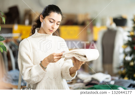 Armenian girl near showcase pick out and buying socks, New Year eve Armenian girl near showcase pick out and buying socks, New Year eve 132044177