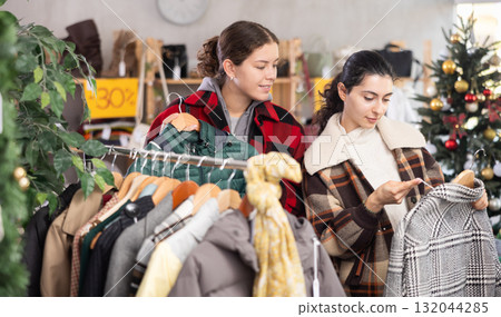 Two women came to a clothing store before Christmas for shopping Two women came to a clothing store before Christmas for shopping 132044285