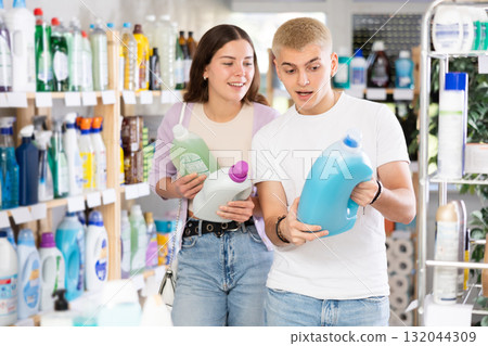 Young couple choosing laundry detergent in department store 132044309