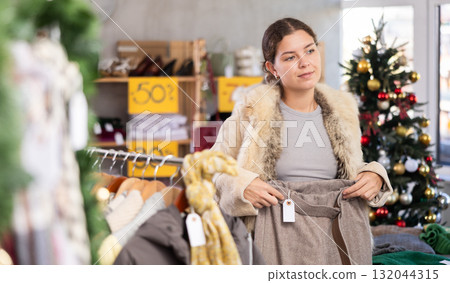 Woman choosing warm pants in the store Woman choosing warm pants in the store 132044315