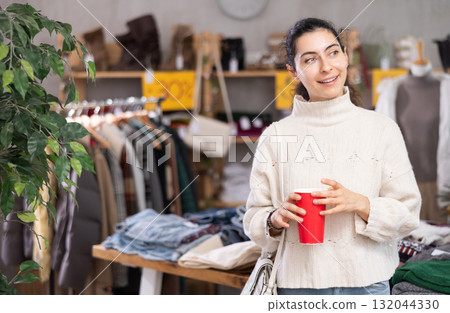 Armenian woman came to a clothing store with a cup of coffee Armenian woman came to a clothing store with a cup of coffee 132044330