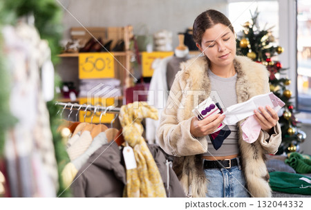 Selective young girl choosing socks in clothing store 132044332