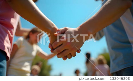 A circle of individuals holding hands, showcasing community support and humanitarian aid for International Day of Charity A circle of individuals holding hands, showcasing community support and humanitarian aid for International Day of Charity 132046208