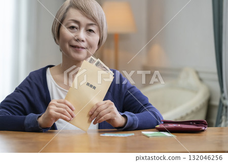 Smiling senior woman preparing medical expenses 132046256