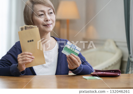 Smiling senior woman preparing medical expenses 132046261