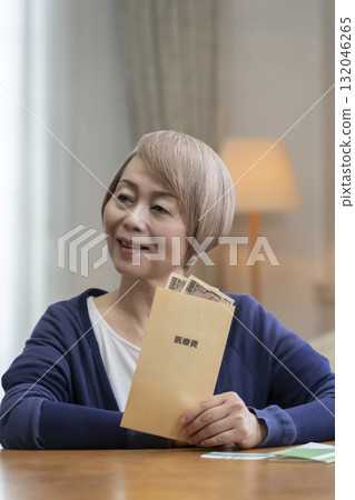 Smiling senior woman preparing medical expenses 132046265