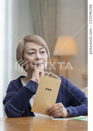 Smiling senior woman preparing medical expenses 132046266