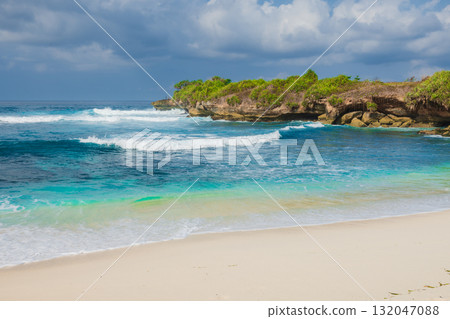 Tropical sandy beach with blue ocean in paradise island, Indonesia Tropical sandy beach with blue ocean in paradise island, Indonesia 132047088