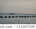 Silhouette of Fisherman on Boat in Calm Waters 132047289