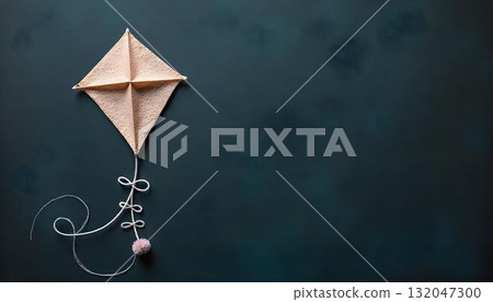 A bright yarn kite hangs from a black background, reflecting the joy and creativity of children on International Children Day 132047300