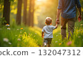 A man and child enjoy a peaceful walk in the woods, celebrating the joy of childhood on International Children's Day 132047312