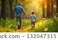 A man and child walk hand in hand along a wooded path, celebrating joy and togetherness on International Children day 132047315