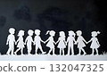 Paper cutout of children holding hands, symbolizing unity and joy for International Children's Day celebration 132047325