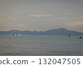 Jet Skis and Kayak on the sea with a chain of hills in the background 132047505