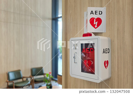 AED or Automated External Defibrillator installed on wall in hotel lobby as first aid in heart attack situation. 132047508